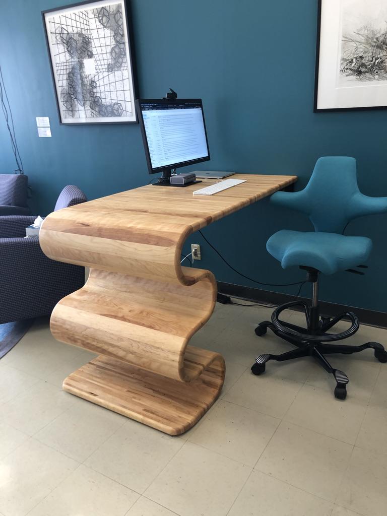 wood desk shaped like a wavy lasagna noodle