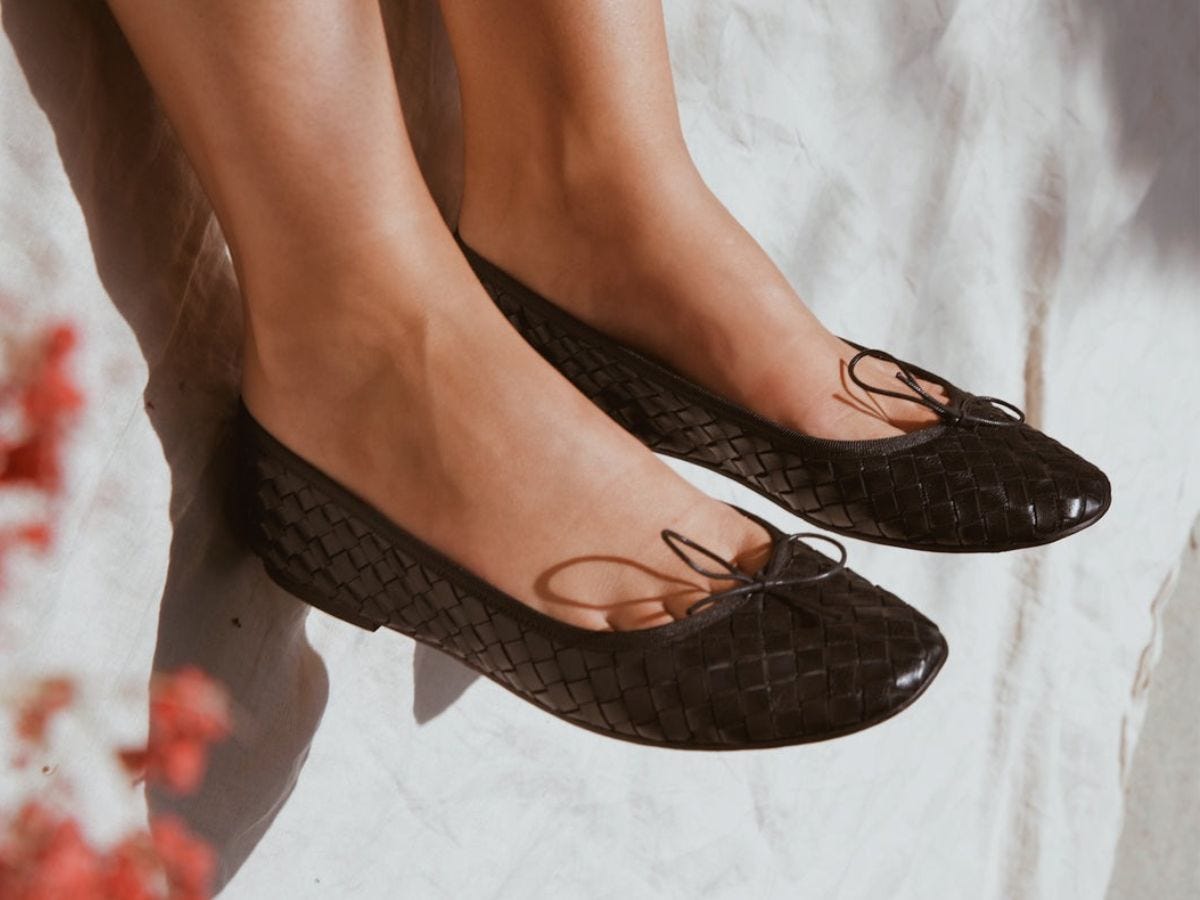 Black woven leather Milaner Nicole ballet flats on model.