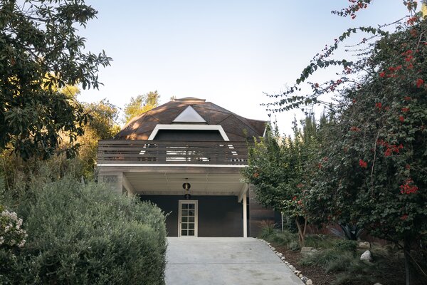 The two-level home sits nestled among thick vegetation, offering a private city oasis.