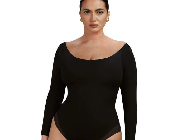 A person wearing the TA3SWIM Scoopy Long Sleeve Bodysuit.