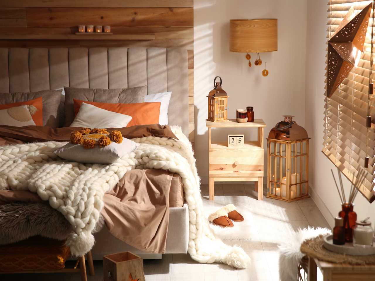 cozy boho bedroom with light wood and orange decor details