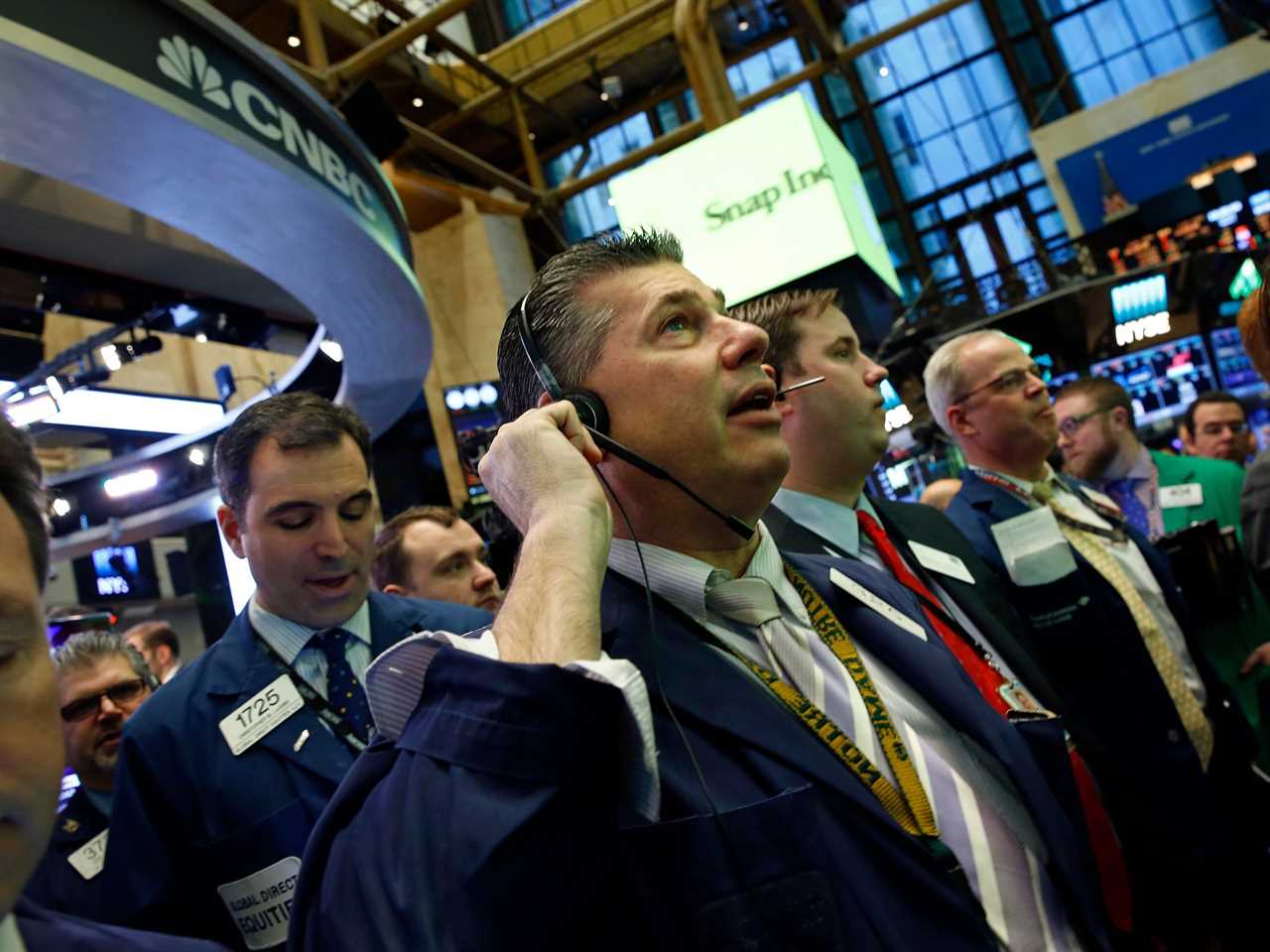 Trader William McInerney, center, and other traders wait for the price to settle on the debut of Snap Inc. on the New York Stock Exchange on March 2, 2017