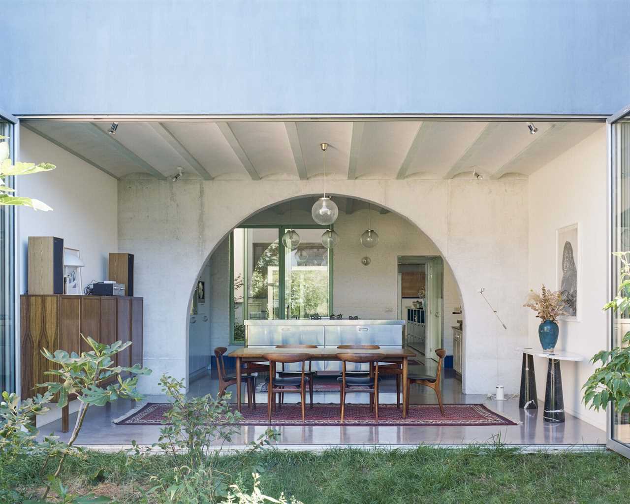 Grooved Red Tile, Arches, and a Catwalk Tie Together a Backyard House in Belgium