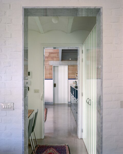 Grooved Red Tile, Arches, and a Catwalk Tie Together a Backyard House in Belgium