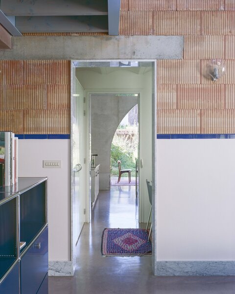 Grooved Red Tile, Arches, and a Catwalk Tie Together a Backyard House in Belgium