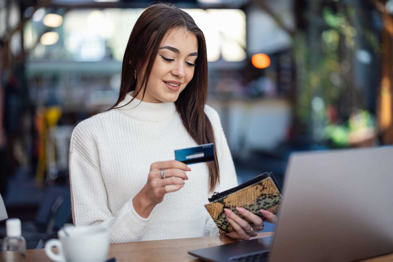 Young woman pays with a credit card.