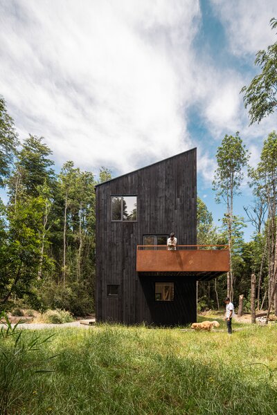 Architects Camilo Fuentealba and Eduardo Díaz created a split-level layout for their vertically aligned home near the Chilean resort town of Puerto Varas. Rooms branch off from a central atrium as you climb up stairs and ladders. 