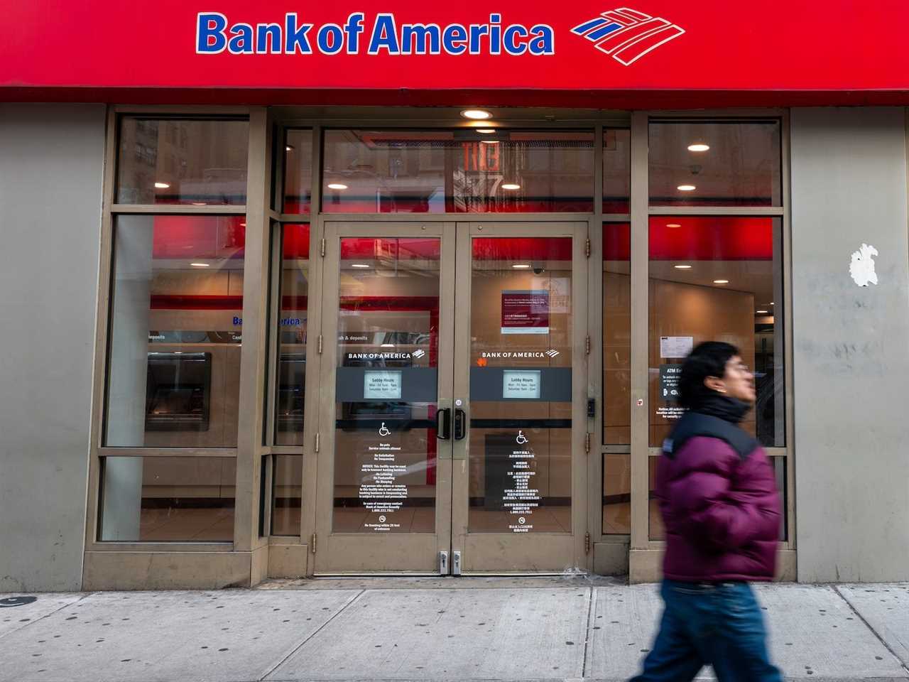 A person walks by a Bank of America location