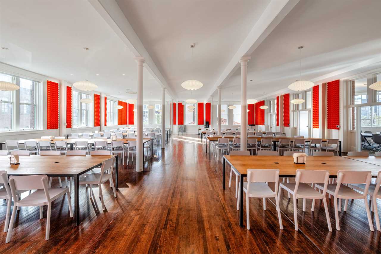 In the main building, the founders share weekly meals in a dining hall padded with orange sound-proofing foam.