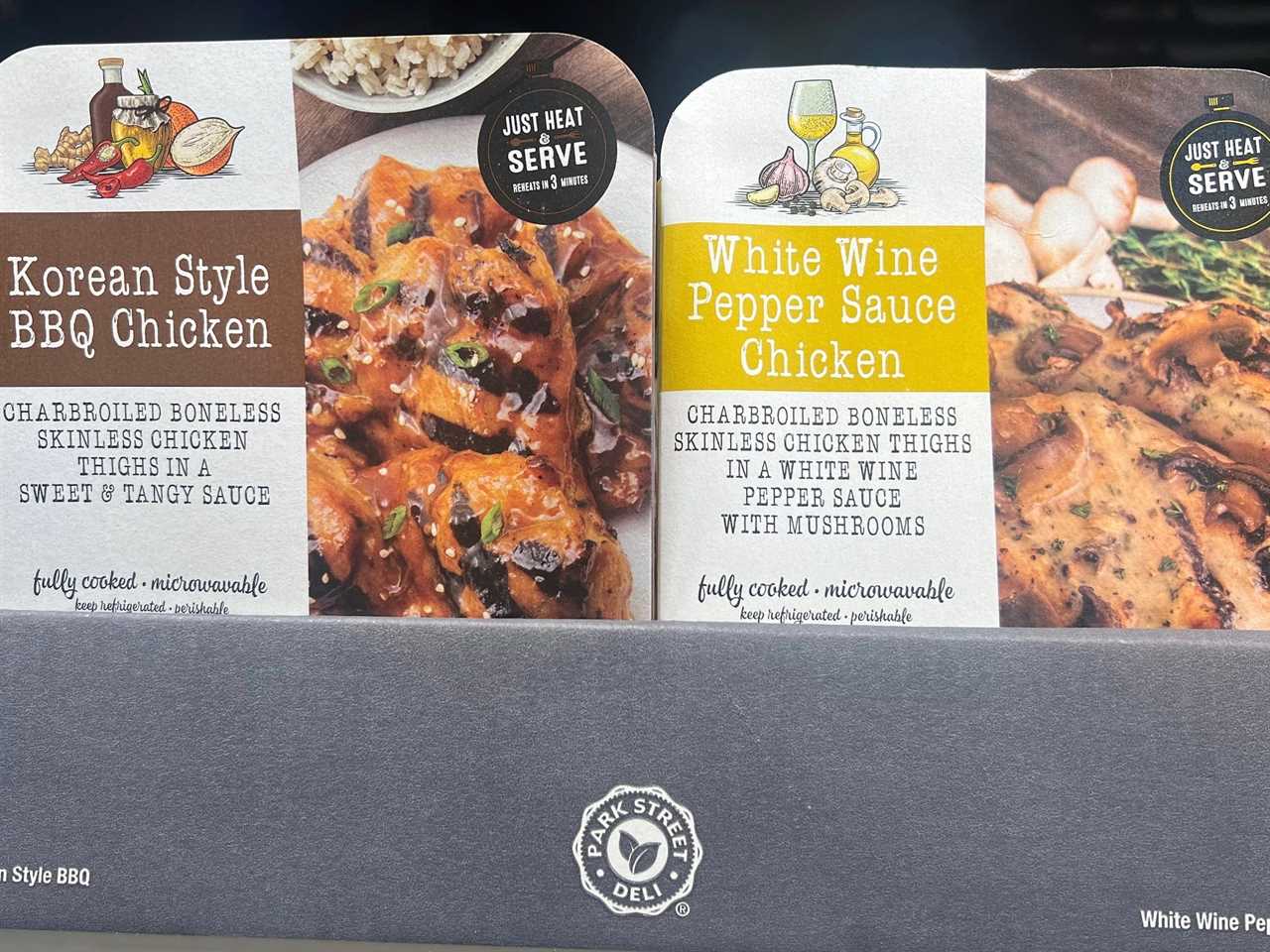 Packages of Korean-style BBQ chicken and white-wine pepper-sauce chicken with images of chicken in sauces on the packaging