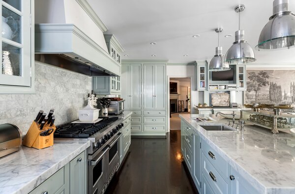 Marble caps the countertops in the airy chef's kitchen, complete with custom cabinetry and high-end appliances.