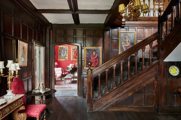 Original details can be found throughout, including oak-paneled walls and flooring in the main hallway.