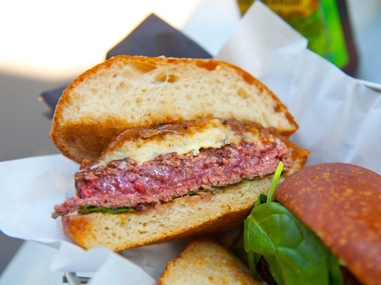 A hamburger cut in half to reveal a rare center