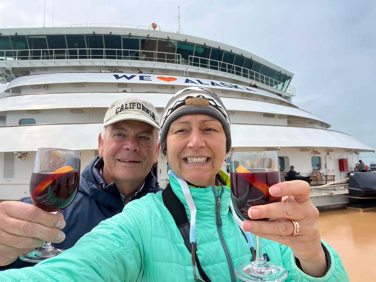 Rebecca Reuter and her husband with wine on a cruise ship