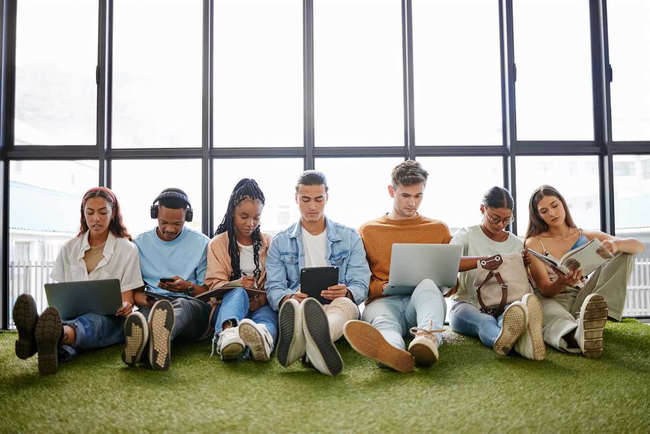 Members of Gen Z sit on computers and tablets.