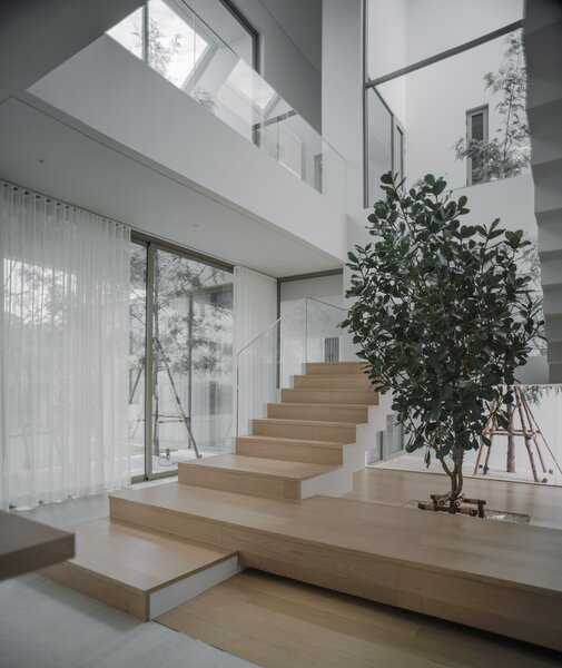 Coming down the stairs, one is able to connect with the large garden through expansive floor-to-ceiling sliding windows. 