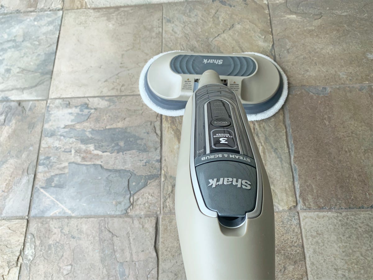 The Shark Steam & Scrub S7001 Mop is cleaning a stone-tiled floor.