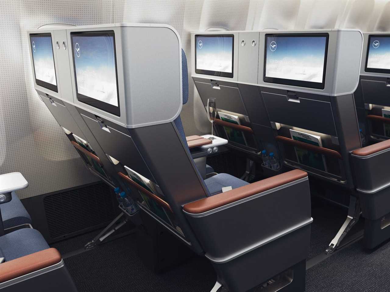 The premium economy seats included in Lufthansa's Allegris layout planes with seatback screens showing.