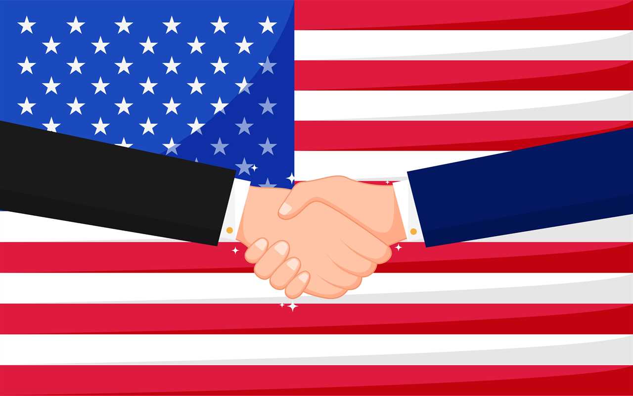 Two men shaking hands with American flag behind them
