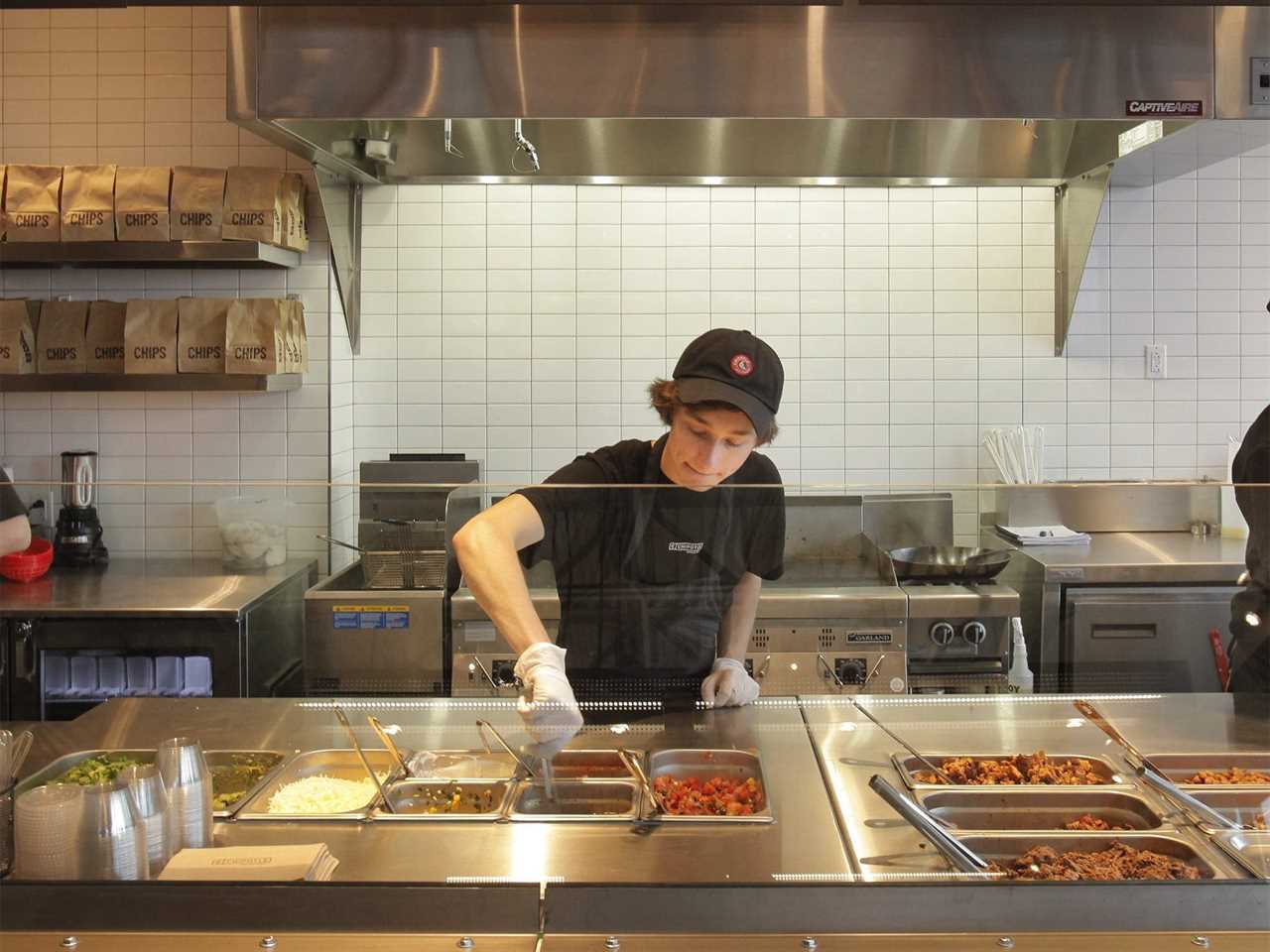 Chipotle worker at assembly line