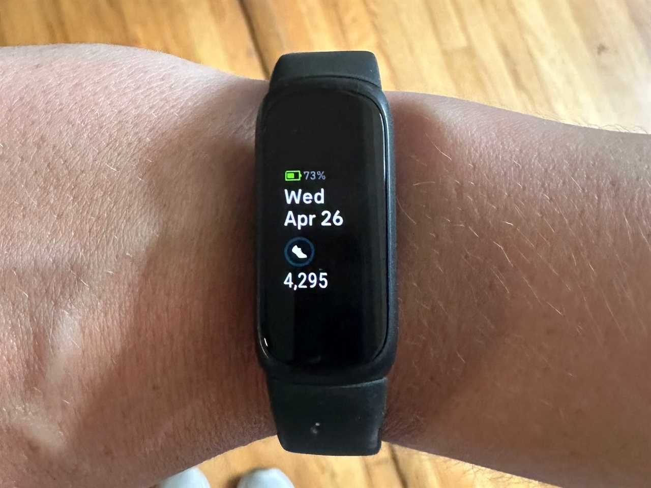 A person wearing a Fitbit Inspire 3 on their wrist.