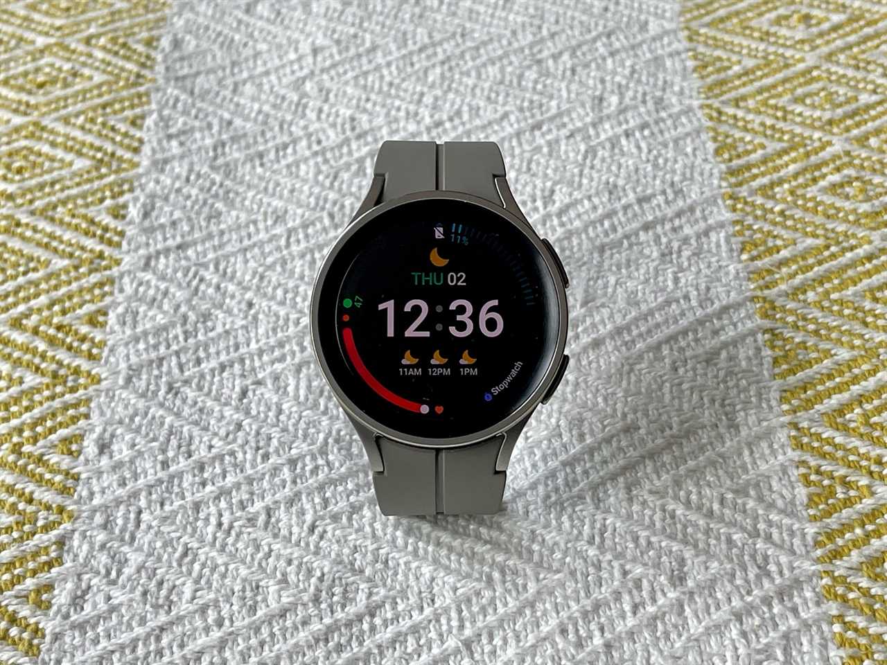 A Samsung Galaxy Watch5 Pro smartwatch on a patterned surface.