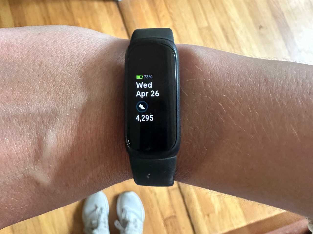 A person wearing a Fitbit Inspire 3 on their wrist.