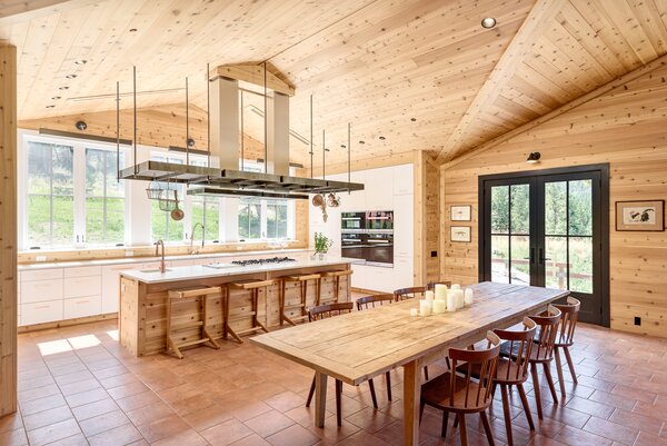 The open kitchen is well equipped for entertaining, complete with long countertops and a full suite of Miele appliances. Custom cabinetry lines the walls, offering plenty of storage.