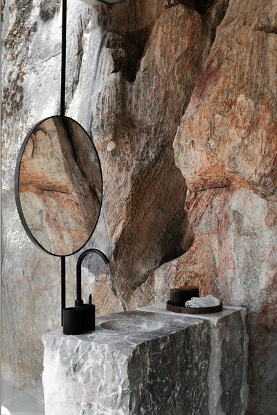 At Las Rocas, architect Ignacio Urquiza and interior designer Ana Paula de Alba sought to integrate nature as much as possible—allowing existing rock formations to define the space complemented by minimalist design elements.