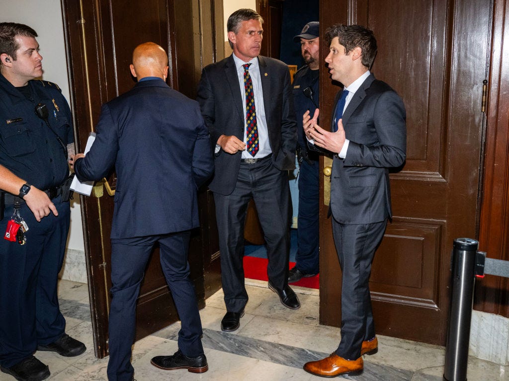 Sam Altman speaks to Democratic Sen. Martin Heinrich during a forum on AI in the Senate.