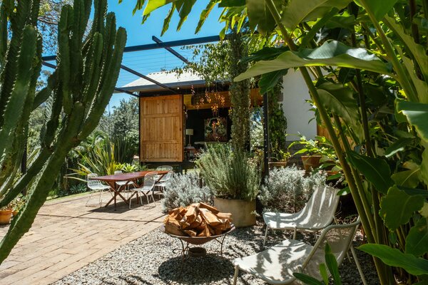 Kenyan designer Naeem Biviji, cofounder of Studio Propolis with his wife, Bethan Rayner, added a 250-square-foot extension to their Nairobi home. The new living room has sliding doors made of recycled wood that open onto a trellis-topped terrace filled with plants grown from clippings harvested from Naeem’s mother’s garden.