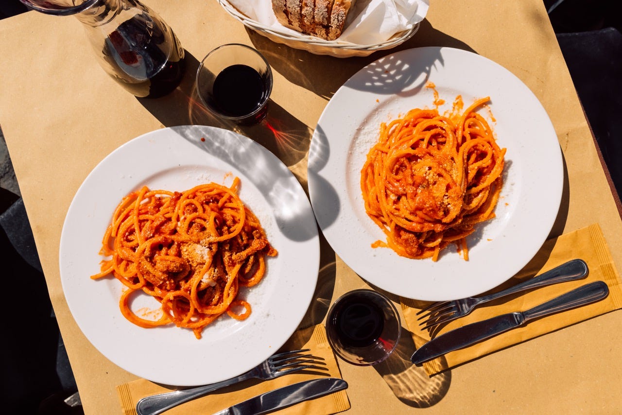 Two plates of pasta at restaurant