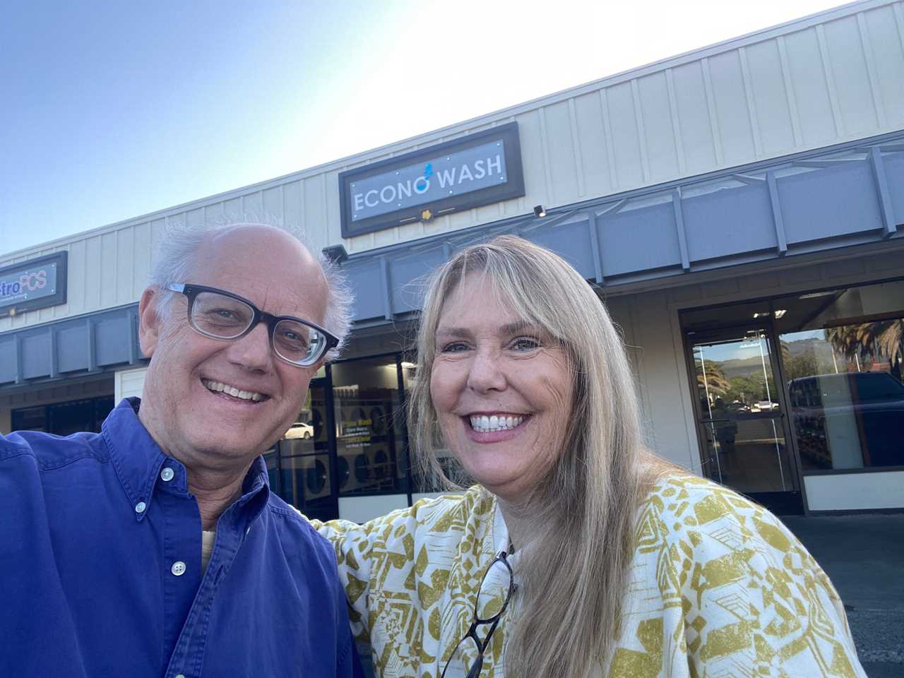 Couple posing in front of laundromat