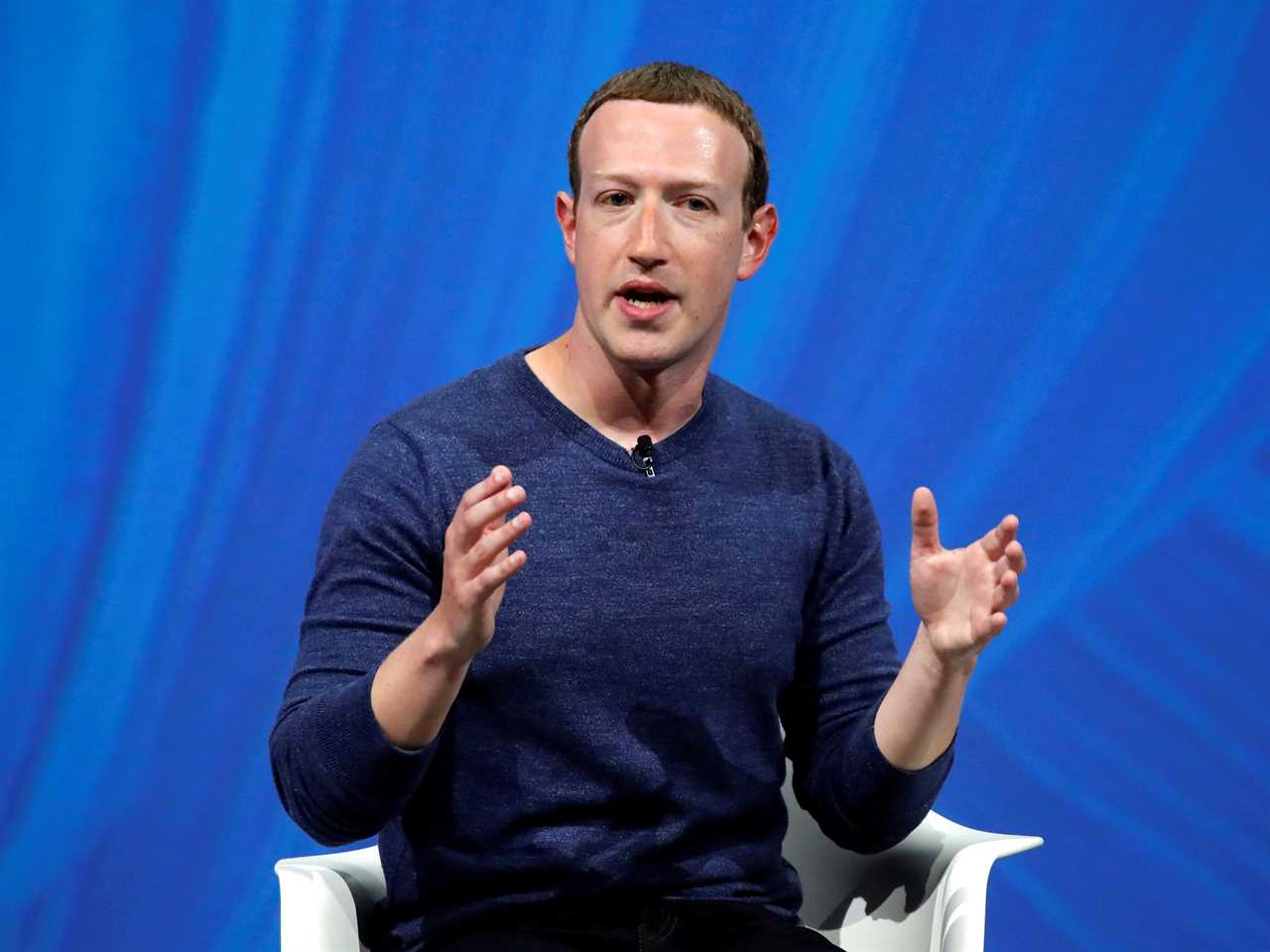 Mark Zuckerberg speaks on stage against a blue background.