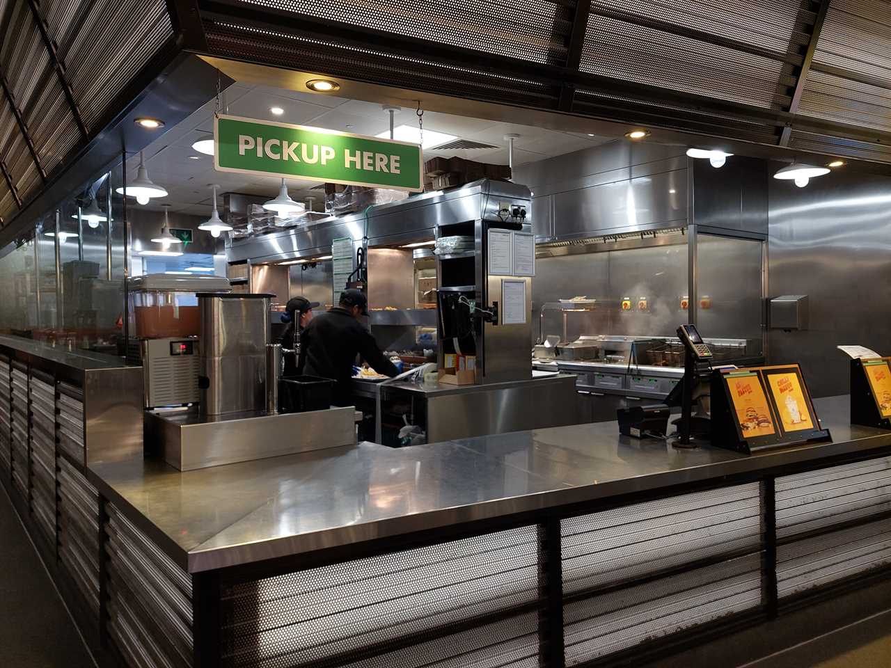 The pickup counter and kitchen in a Shake Shack restaurant in London