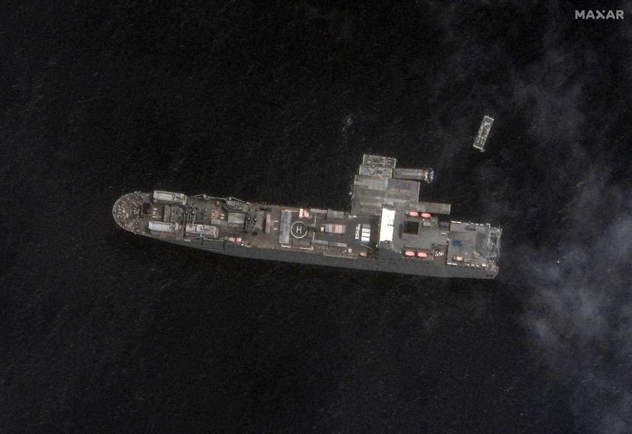 An aerial view of USNS Roy P. Benavidez carrying the floating dock sections