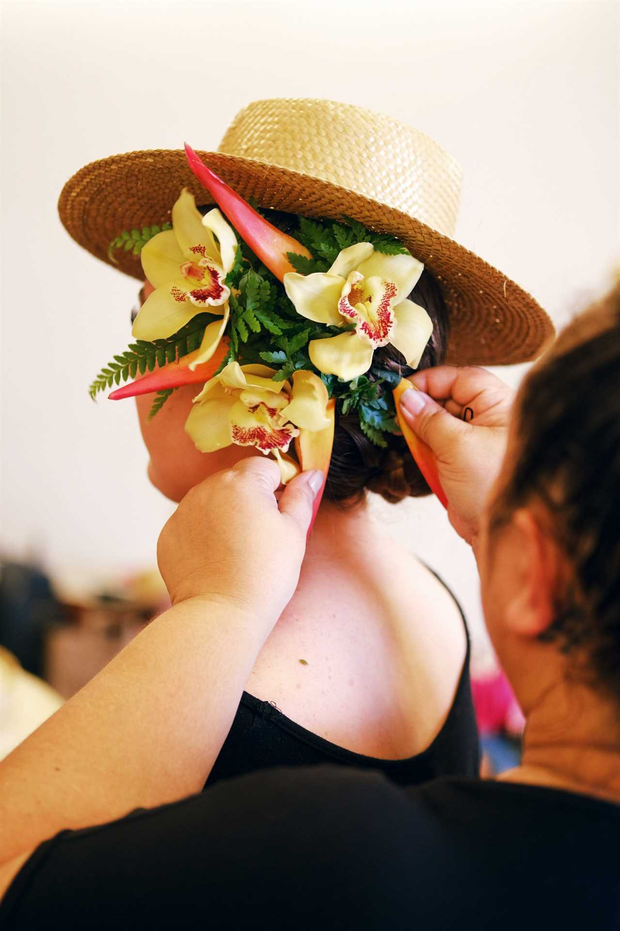 Putting flowers on styled hair.