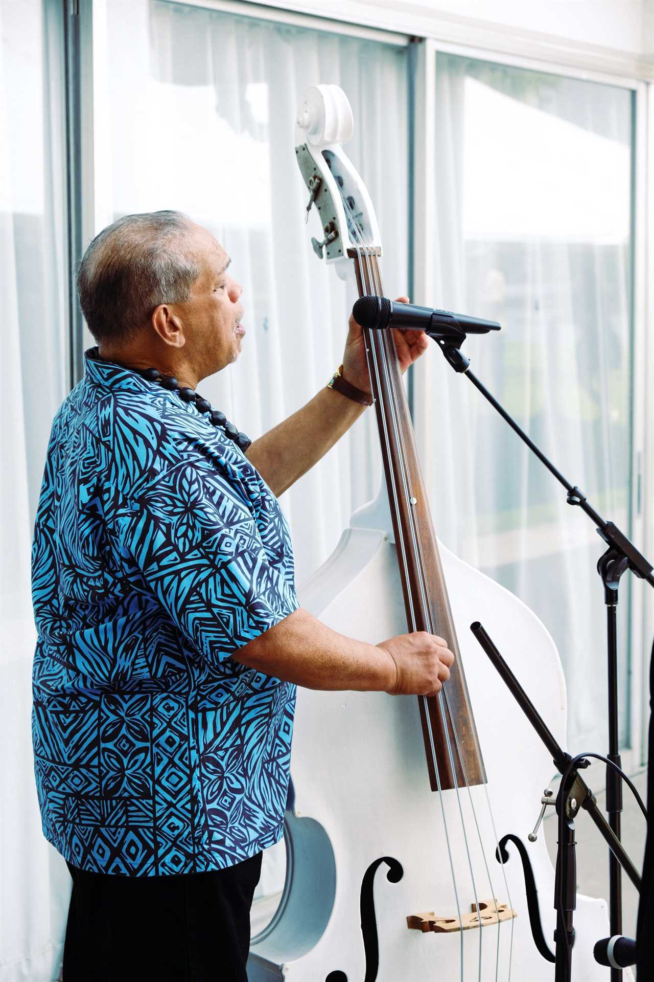 Man sings and plays the cello.