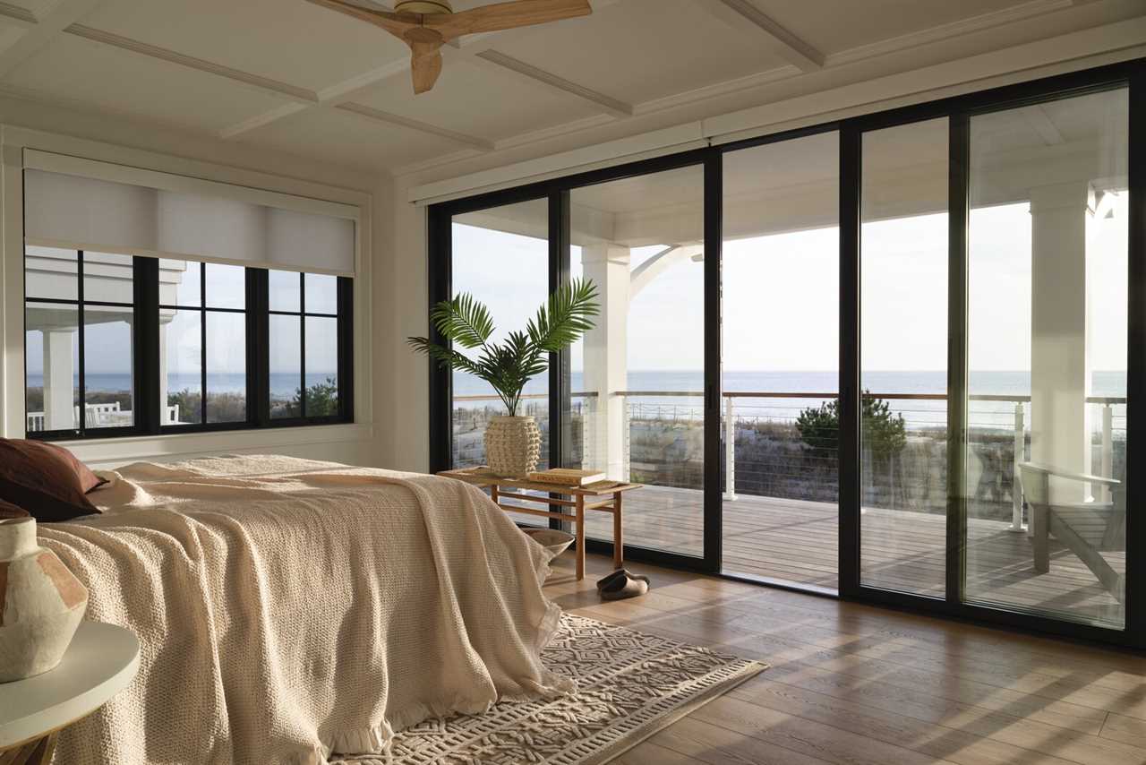 The corner bedroom’s inspired ocean view is made possible by wall-to-wall Marvin Modern Multi-Slide doors.