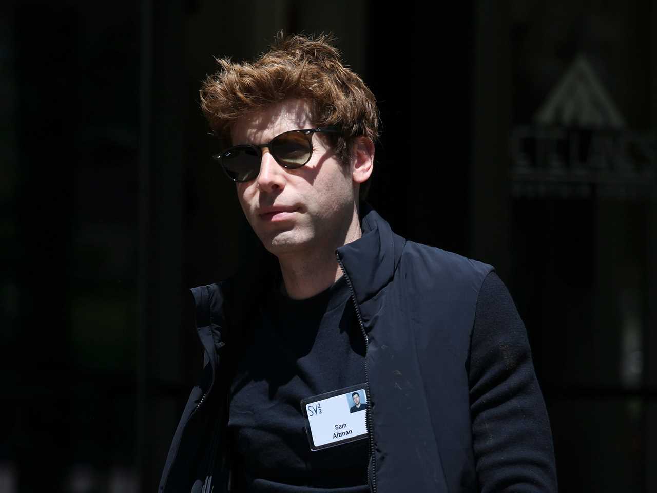 Sam Altman walking with sunglasses