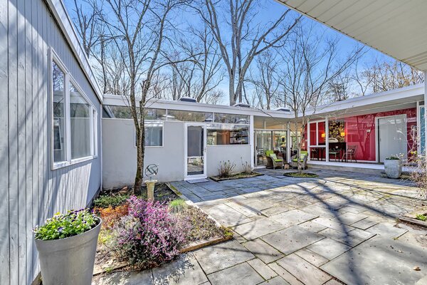 Nestled on a tree-filled lot, the home revolves around an expansive bluestone courtyard.