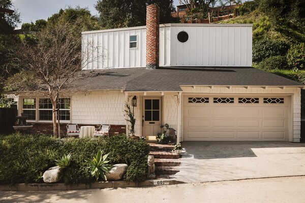 The two-story home sits nestled on a quiet cul-de-sac, surrounded by lush greenery.