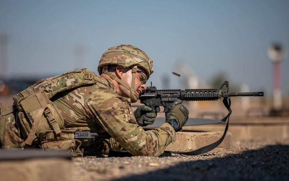 An Army Staff Sgt shoots an M4A1 Carbine semi automatic rifle