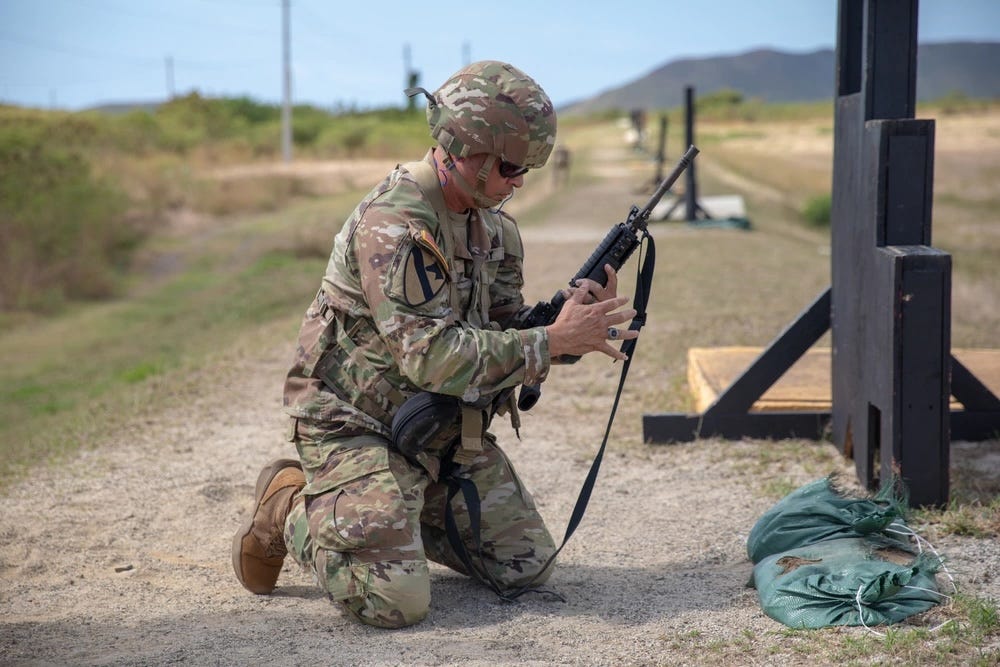 A US Army soldier reloads an M4A1 carbine