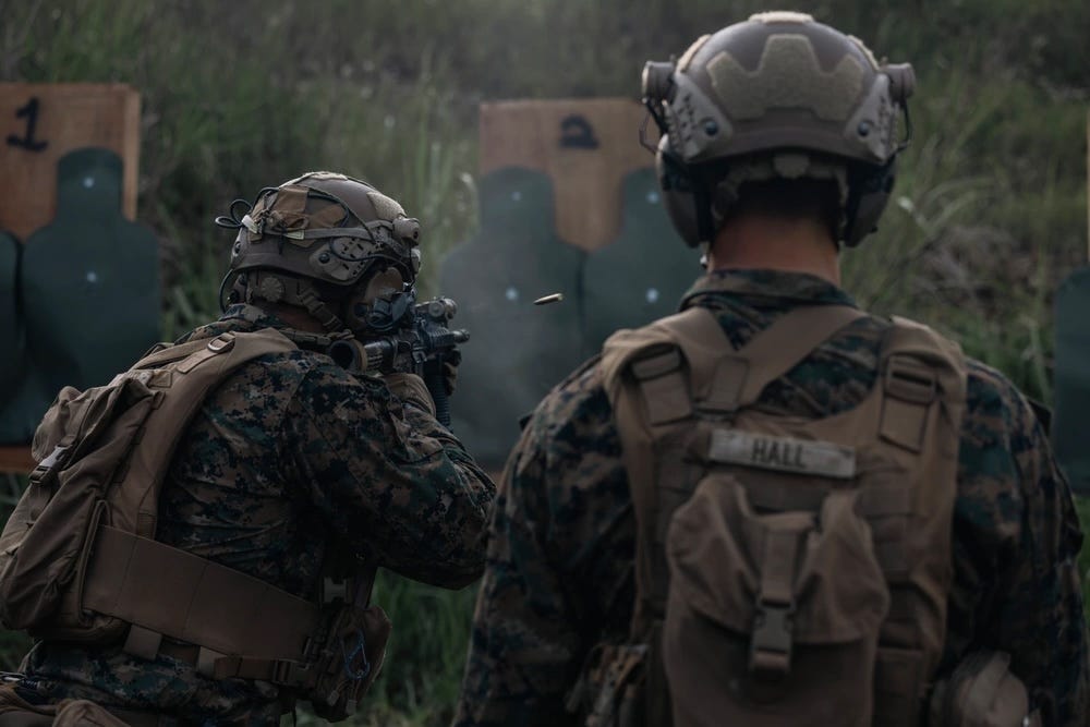 A US Marine fires a M4A1 carbine at a target