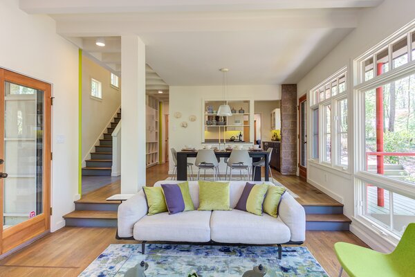 Expansive windows in the main living areas frame striking views of the surrounding forest.