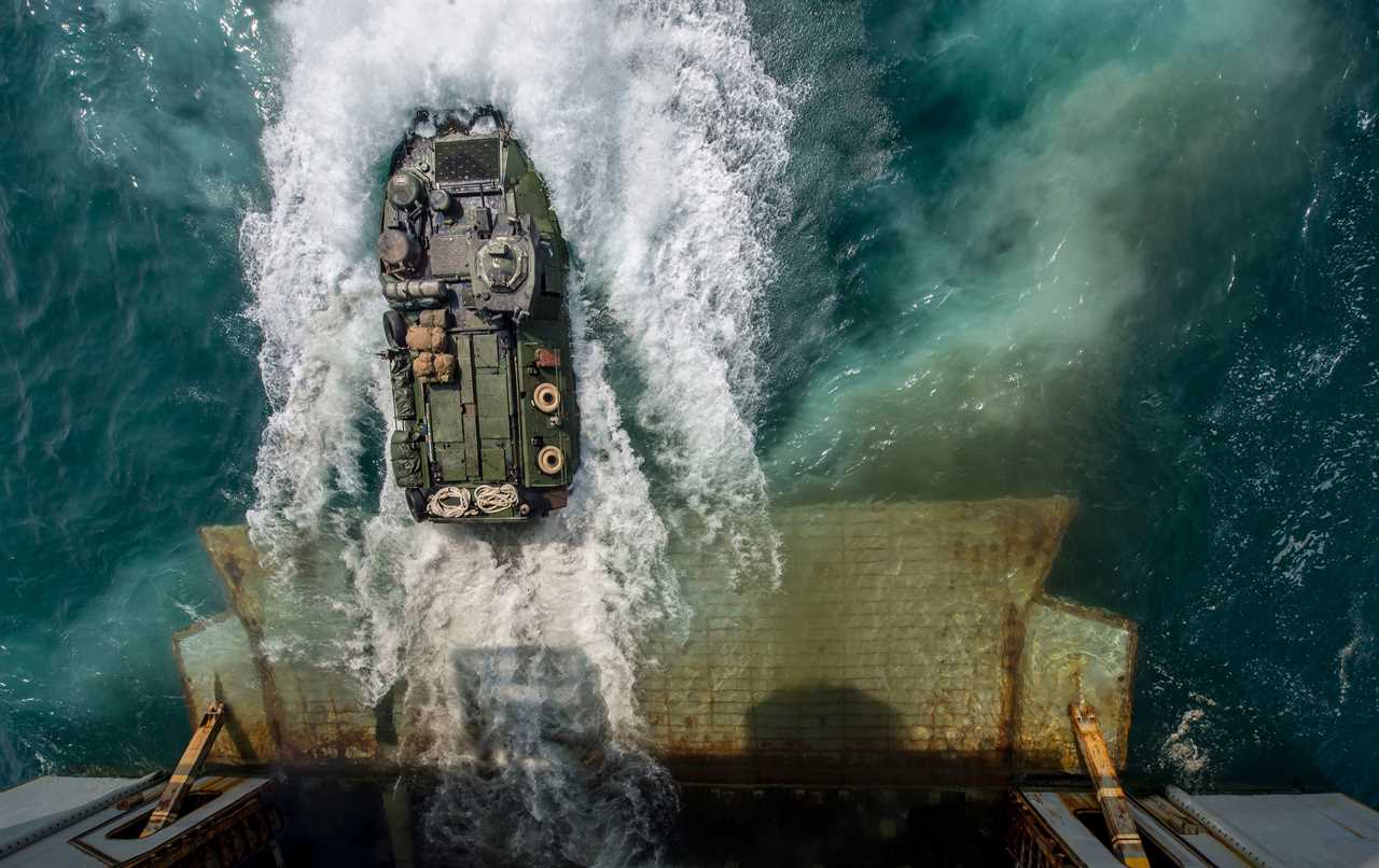 Arabian Gulf, August 24, 2014 - Marines aboard an amphibious assault vehicle (AAV) exit the well deck of the amphibious assault ship USS Bataan (LHD 5).