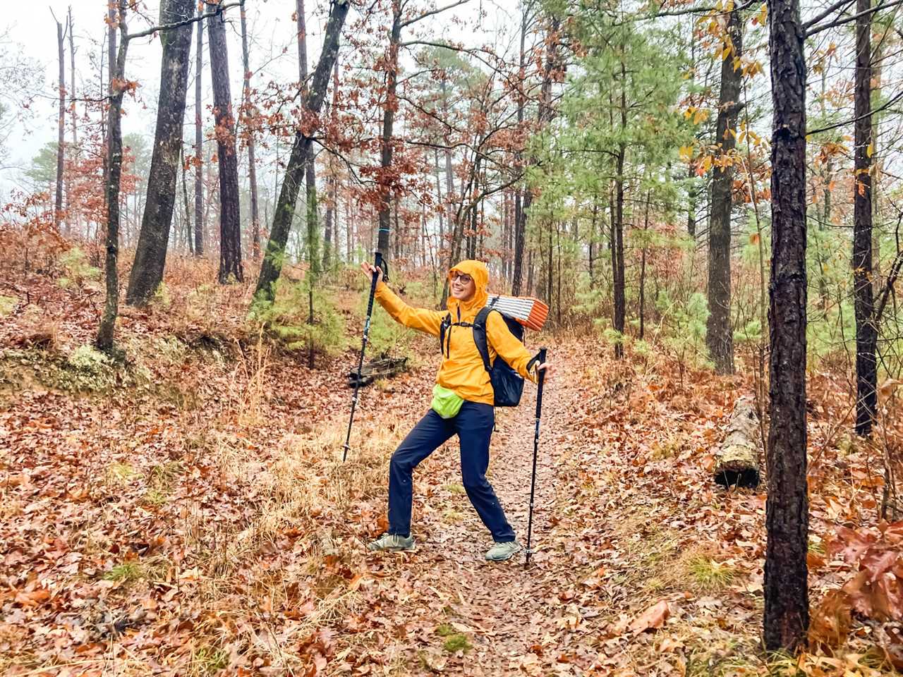 Alisha McDarris hiking in leaves with hiking poles 