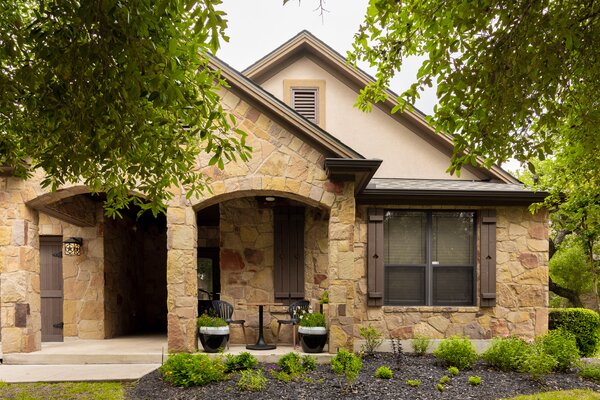 The ranch-style stone home was constructed in 2007 as part of a planned community in Austin, Texas, and features four bedrooms and two-and-a-half baths. The original owner extended the footprint with a light-filled sunroom that current owner Robert Gibby uses as an office.