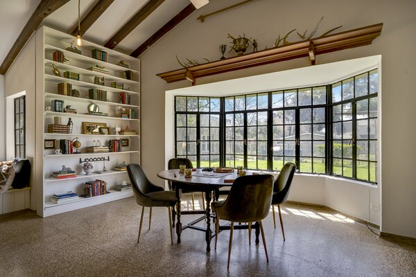 Soaring 12-foot-high vaulted ceilings cap the main living areas, lined with terrazzo flooring.